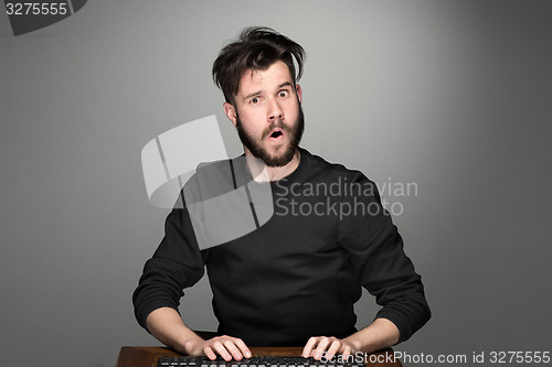 Image of Crazy businessman sitting at table