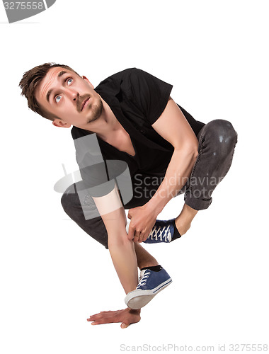 Image of Break dancer doing one handed handstand against a white background