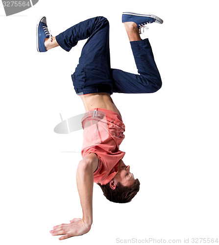 Image of Break dancer doing one handed handstand against a white background