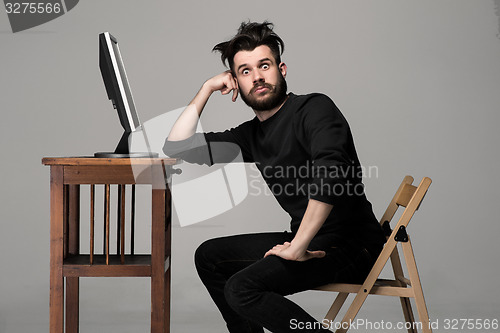 Image of Funny and crazy man using a computer