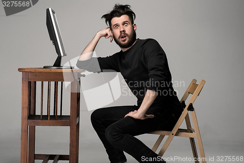 Image of Funny and crazy man using a computer