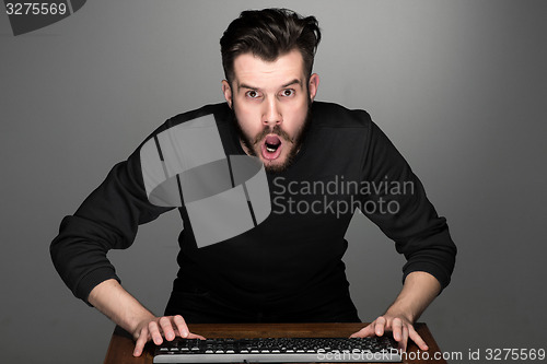 Image of Crazy businessman sitting at table