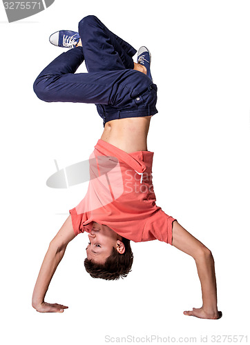 Image of Break dancer doing handstand against  white background