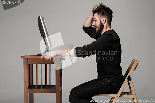 Image of Funny and crazy man using a computer