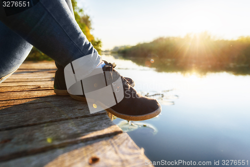 Image of Woman relaxing on jetty