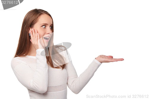 Image of Surprised woman showing open hand palm