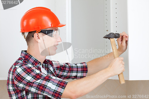 Image of worker with a hammer