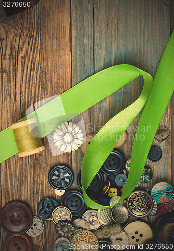 Image of set of vintage buttons with green tape and spool of thread