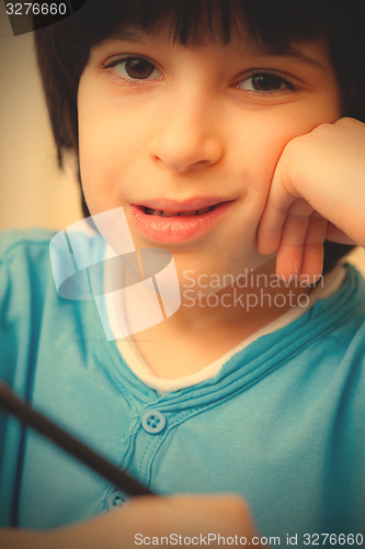 Image of boy portrait with pen