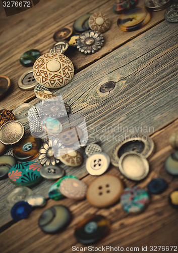 Image of placer of vintage buttons on aged boards
