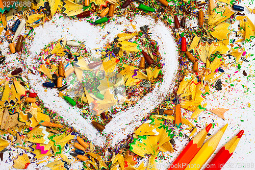 Image of heart, multicolored pencils and varicolored shavings
