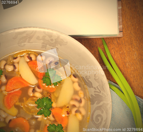 Image of bean soup with carrots, potatoes, parsley and onions