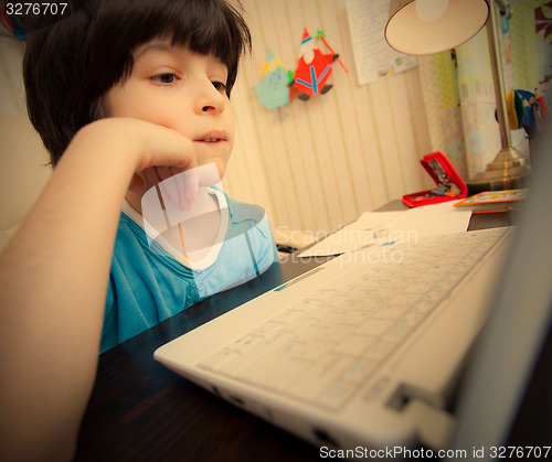 Image of distance learning, a child with computer