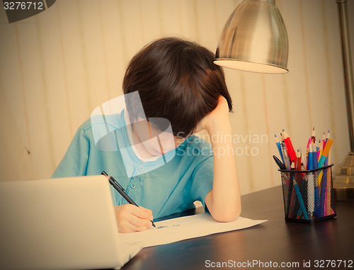 Image of schoolboy doing homework