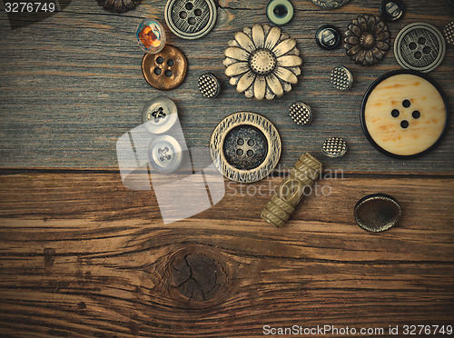 Image of Vintage buttons on the old wooden surface