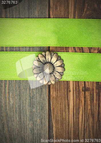 Image of vintage button flower and two green tapes