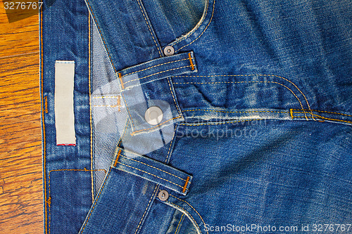 Image of indigo jeans with a button