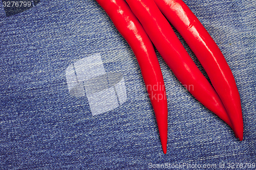 Image of red pepper on jeans background