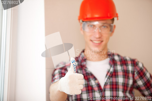 Image of young construction worker with thumbs up