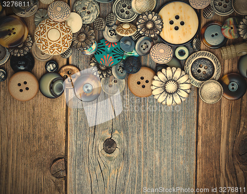 Image of intage buttons on aged boards surface