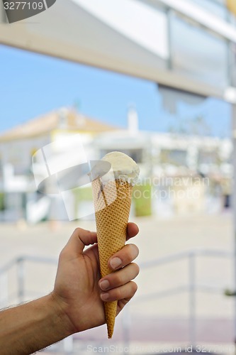 Image of Hand holding pink ice-cream