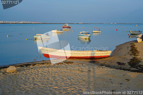 Image of Photo of boats at sunset