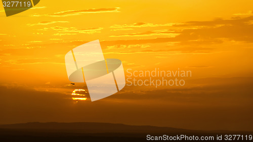 Image of Skyscape with plane at sunset