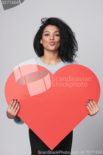 Image of Girl holding big red heart shape