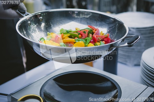 Image of cooking vegetables in wok pan