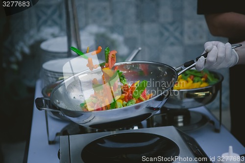 Image of cooking vegetables in wok pan