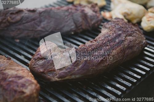 Image of Meat on BBQ. Shallow DOF.