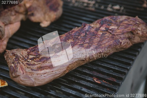Image of Meat on BBQ. Shallow DOF.