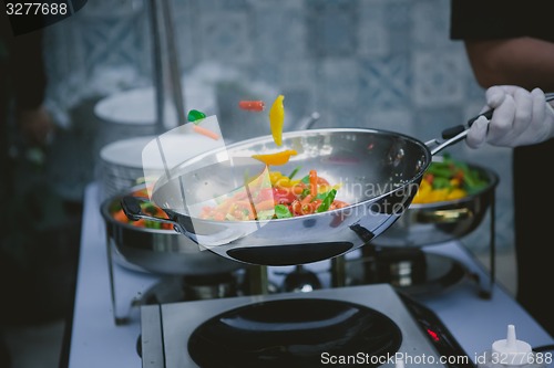 Image of cooking vegetables in wok pan