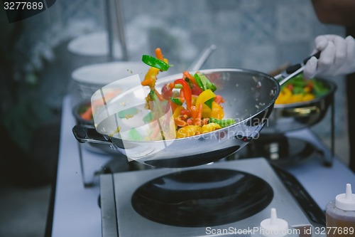 Image of cooking vegetables in wok pan