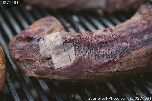 Image of Meat on BBQ. Shallow DOF.