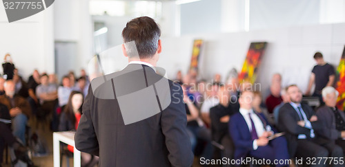 Image of Speaker at Business Conference and Presentation.