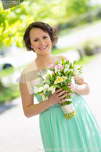 Image of Happy bride with wedding bouquet.