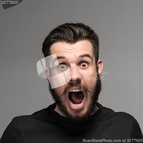 Image of Portrait of a young surprised businessman with opened mouth
