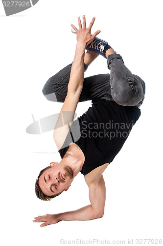 Image of Break dancer doing one handed handstand against a white background