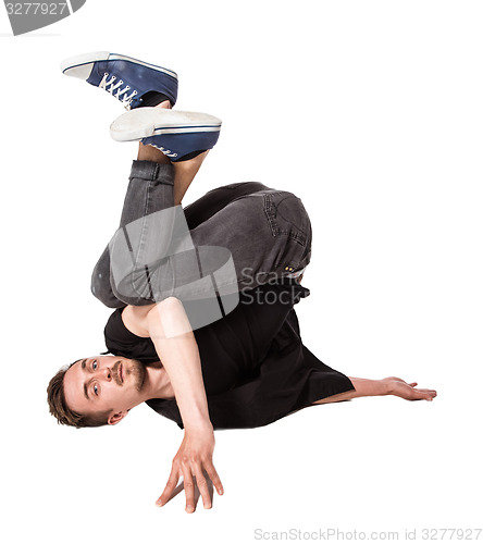 Image of Break dancer doing one handed handstand against a white background