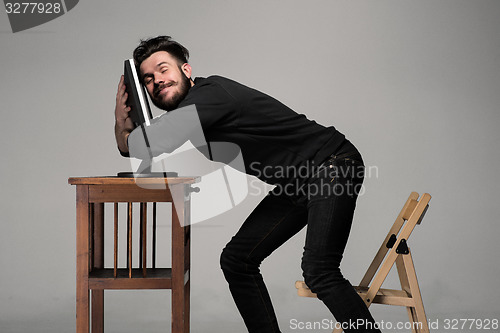 Image of Funny and crazy man using a computer