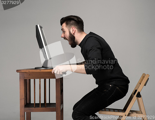 Image of Funny and crazy man using a computer