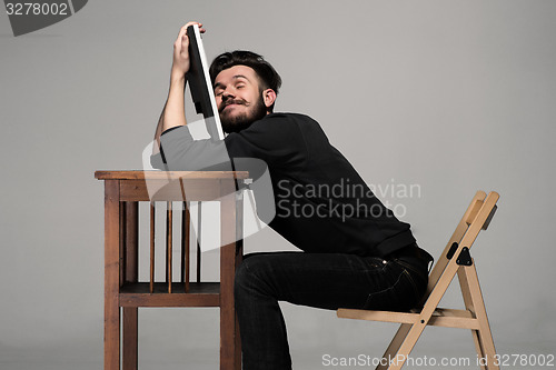 Image of Businessman sleeping on a computer