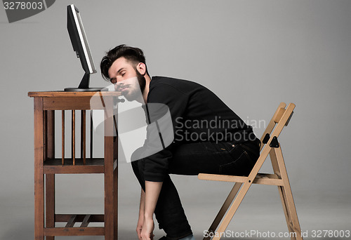 Image of Businessman sleeping on a computer