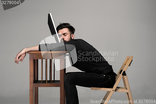 Image of Businessman sleeping on a computer