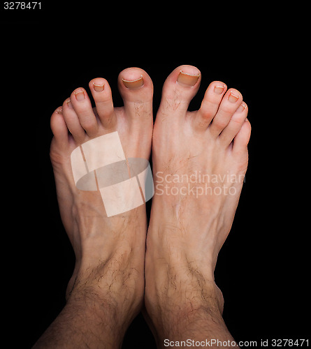 Image of Pair of caucasian male feet isolated towards black