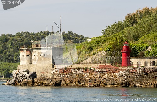 Image of Little lighthouse on a rocky shore