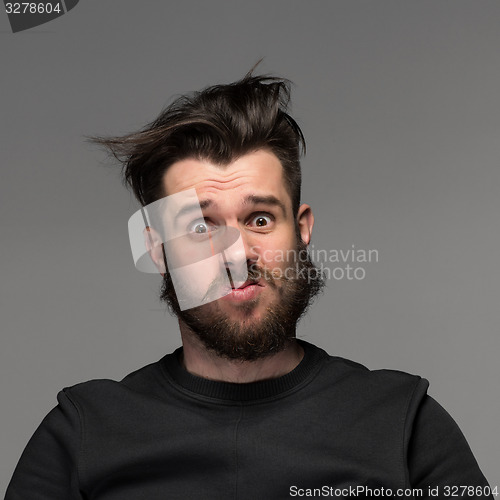 Image of Portrait of young tousled man in studio