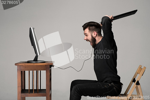 Image of Angry man is destroying a keyboard