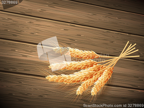 Image of Wheat on wooden background. EPS 10 